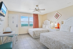 Double queen room with tropical decor and pool view at Glunz Ocean Beach Resort