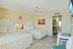 Double queen room with tropical decor and pool view at Glunz Ocean Beach Resort