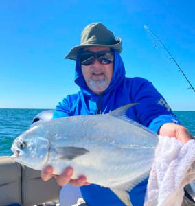 Captain Doug Kelley holding a fish