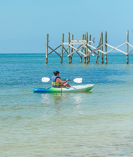 woman kayaking on the beach